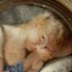 19th century miniature of a young girl with her head resting on a cushion