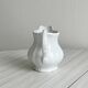 Old white porcelain milk jug, cream jug with relief.