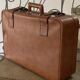 Antique suitcase with brown leather straps