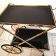 Golden brass trolley wheeled dessert and glass trays