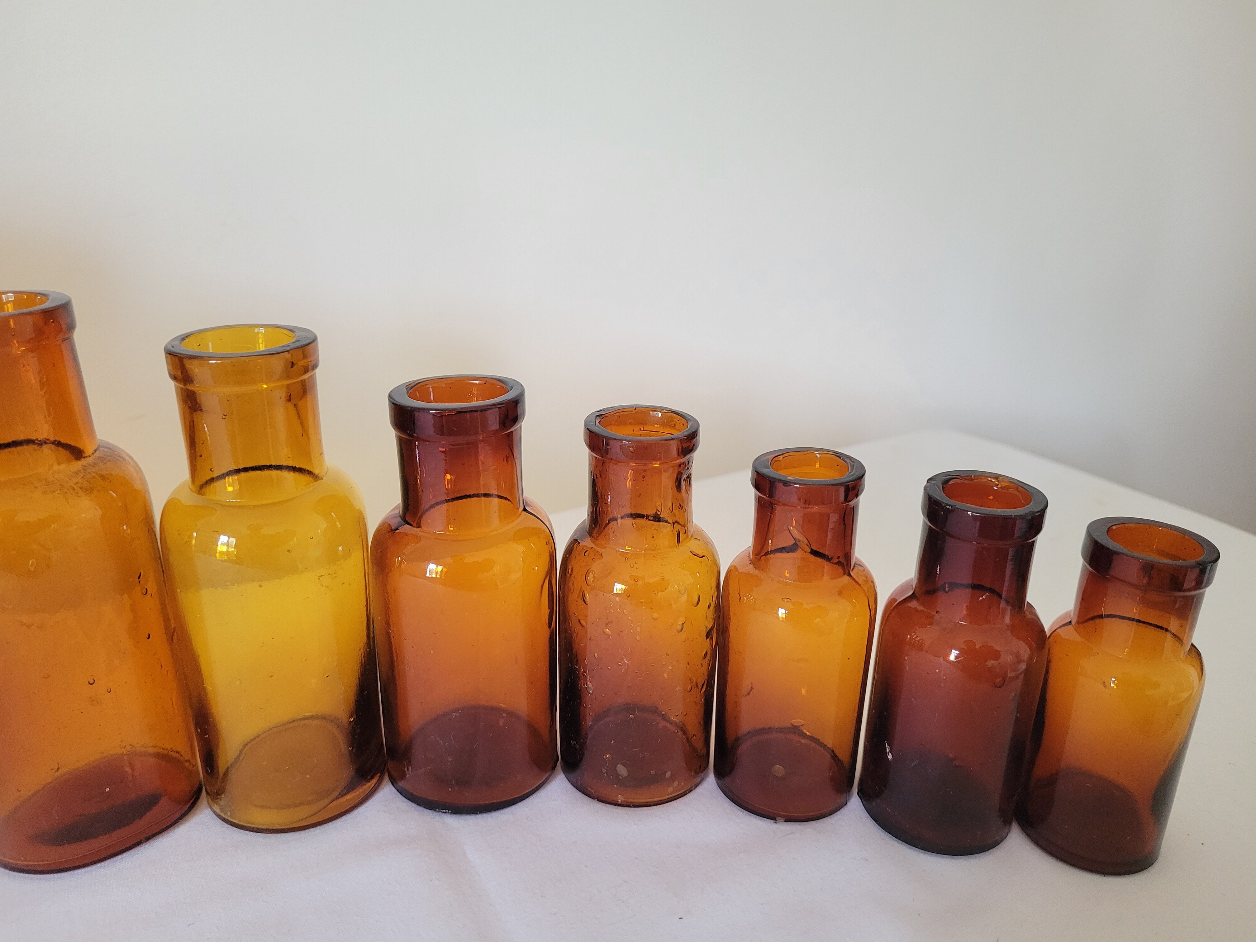 11 bottles of amber glass apothecary