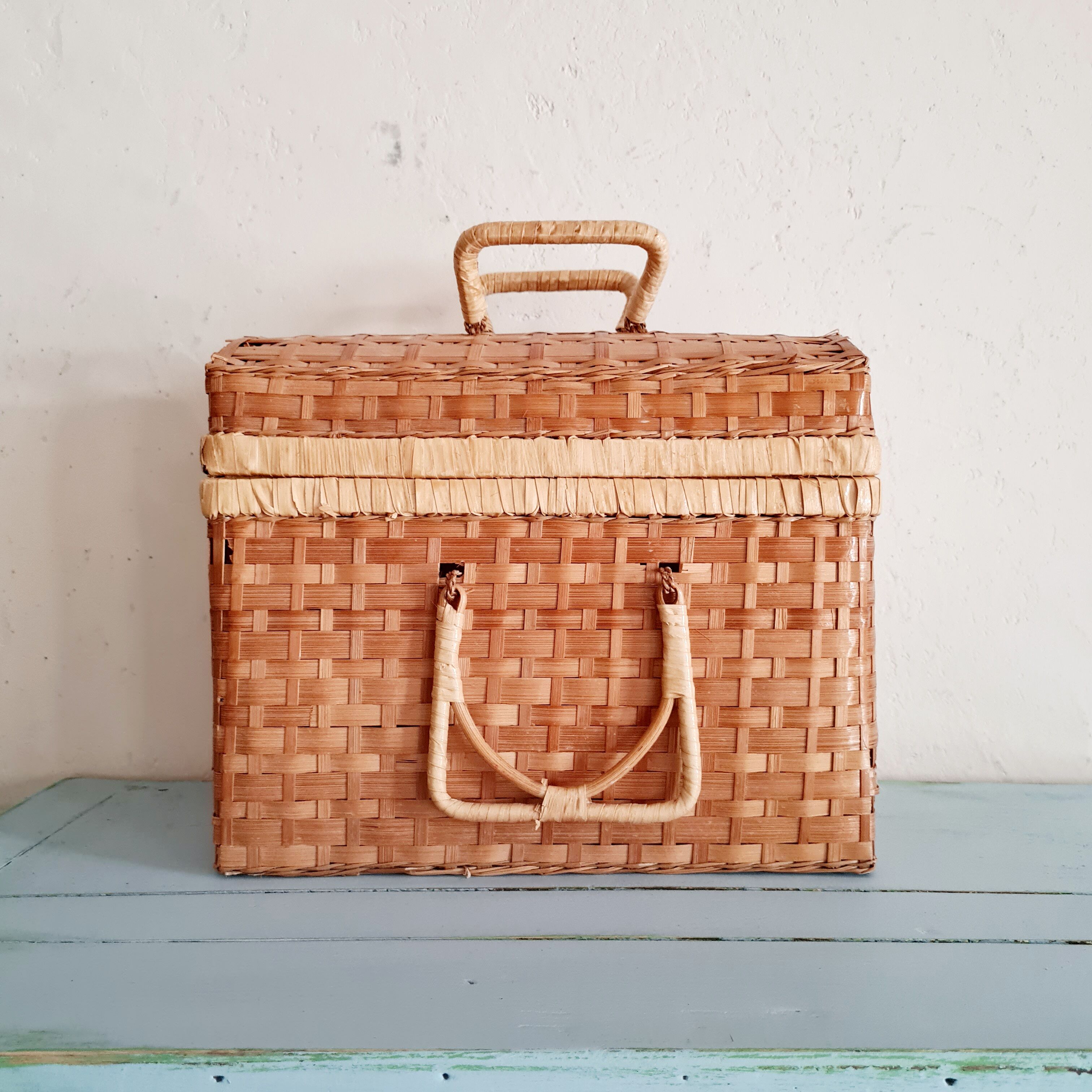 Small suitcase in vintage rattan trunk