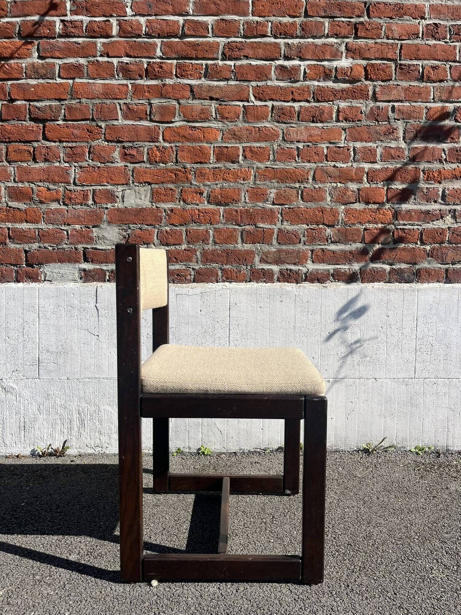 Many mid-century vintage wooden and fabric chairs.