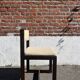 Many mid-century vintage wooden and fabric chairs.