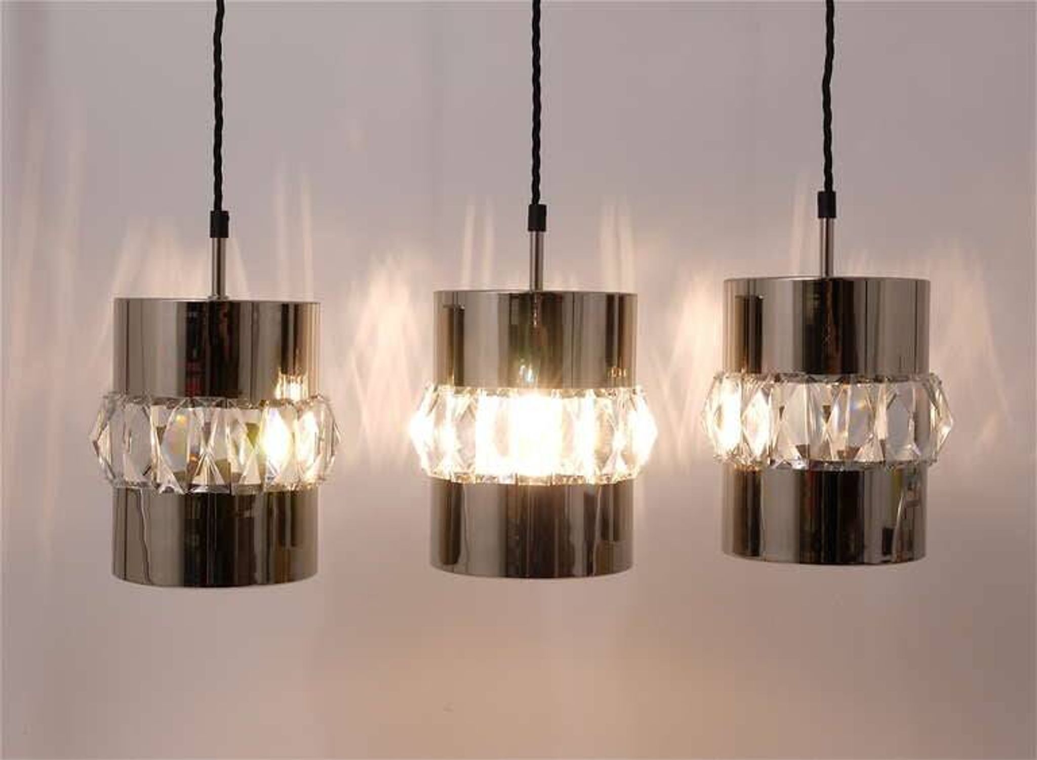 Three Bakalowits pendant lamps in nickel, brass, and faceted crystal, Austria, 1950s.