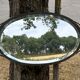 Bevelled oval mirror, richly crafted Art Deco wrought iron.