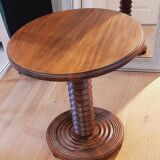 Brutalist side table with turned wood and wine press leg.