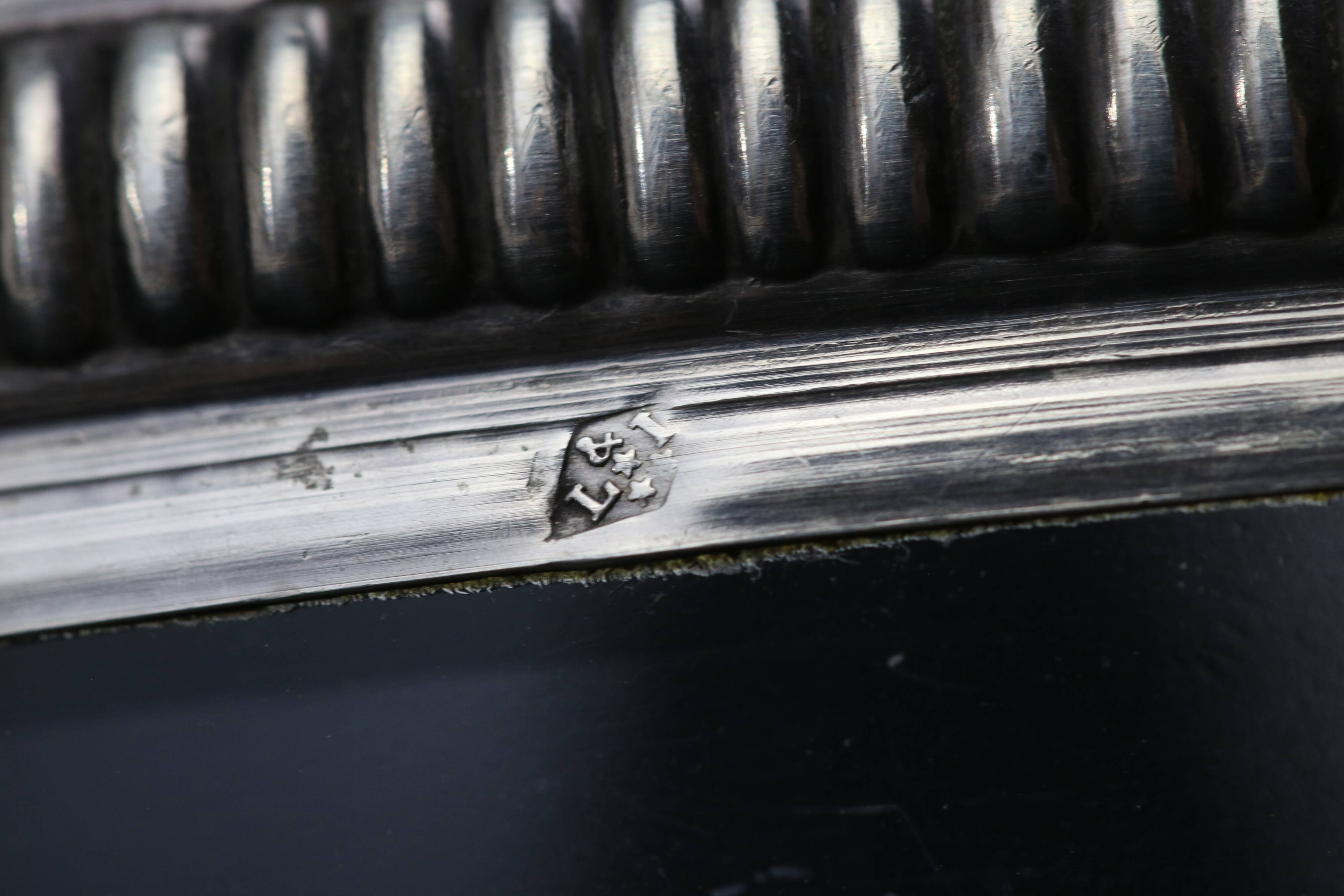 Crystal cup surrounded by two silver friezes