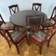 Round mahogany table and beech chairs.