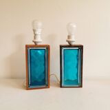 Two Swedish table lamps in solid pressed blue glass and teak wood "frame".