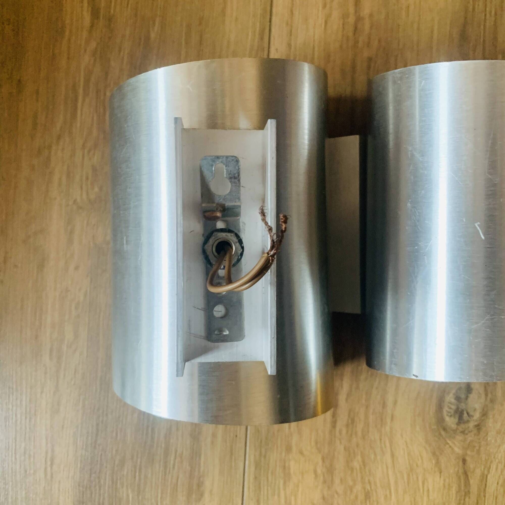 Pair of Space Age wall lights in brushed metal with a copper-orange interior.