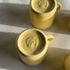 Set of 4 vintage yellow Italian espresso cups and saucers.
