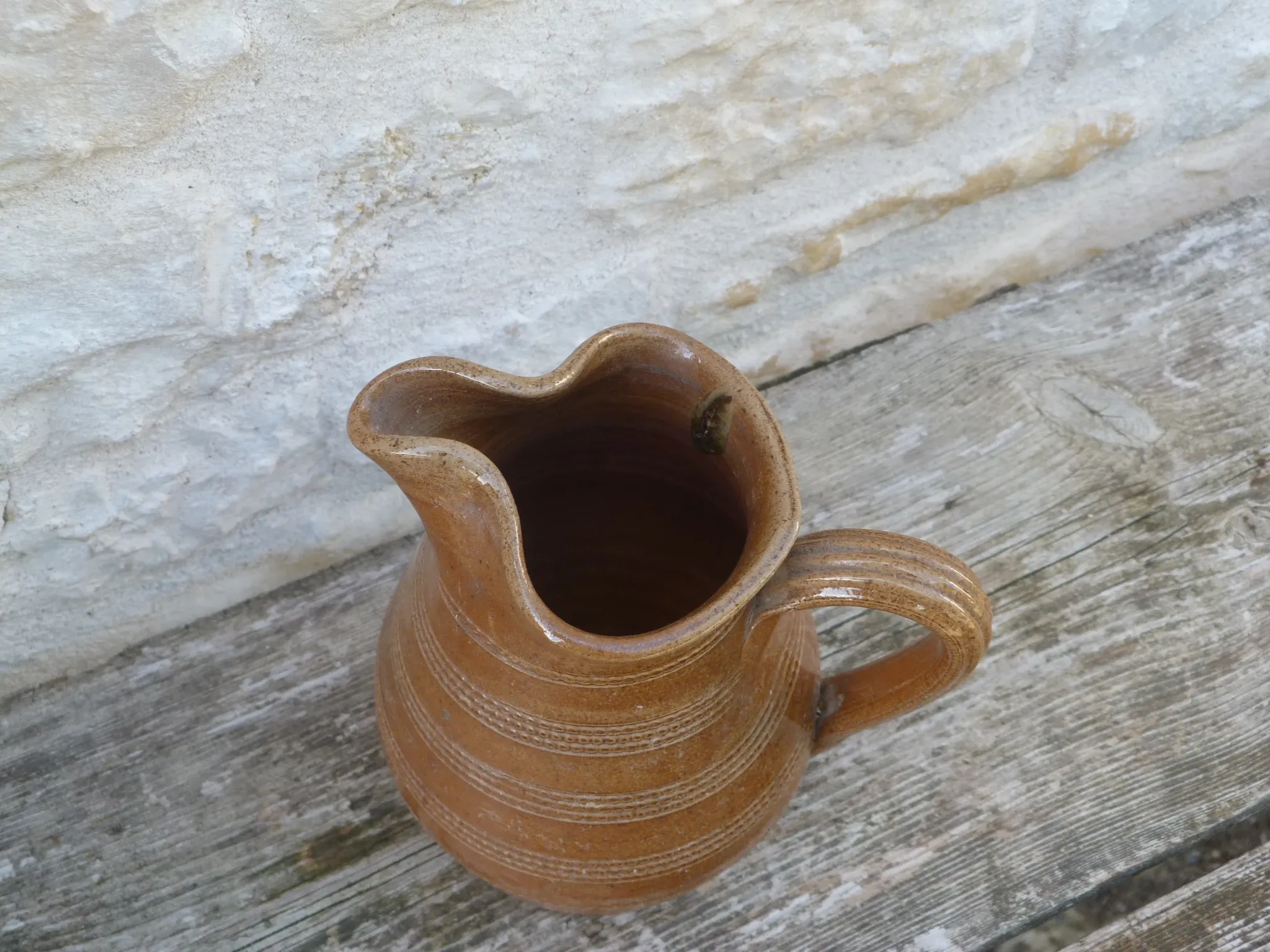Old stoneware wine jug with patterns