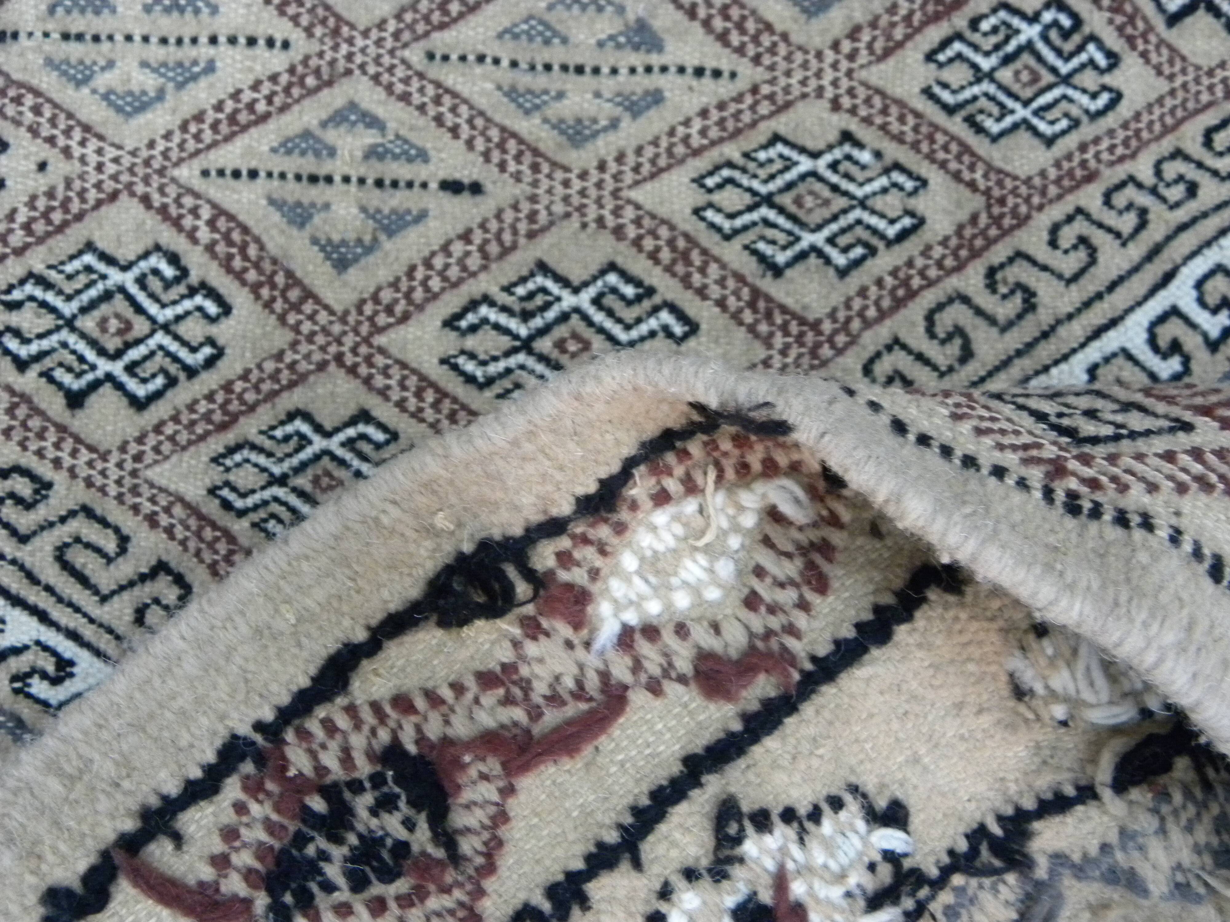Traditional handmade Berber carpet in brown and beige wool.