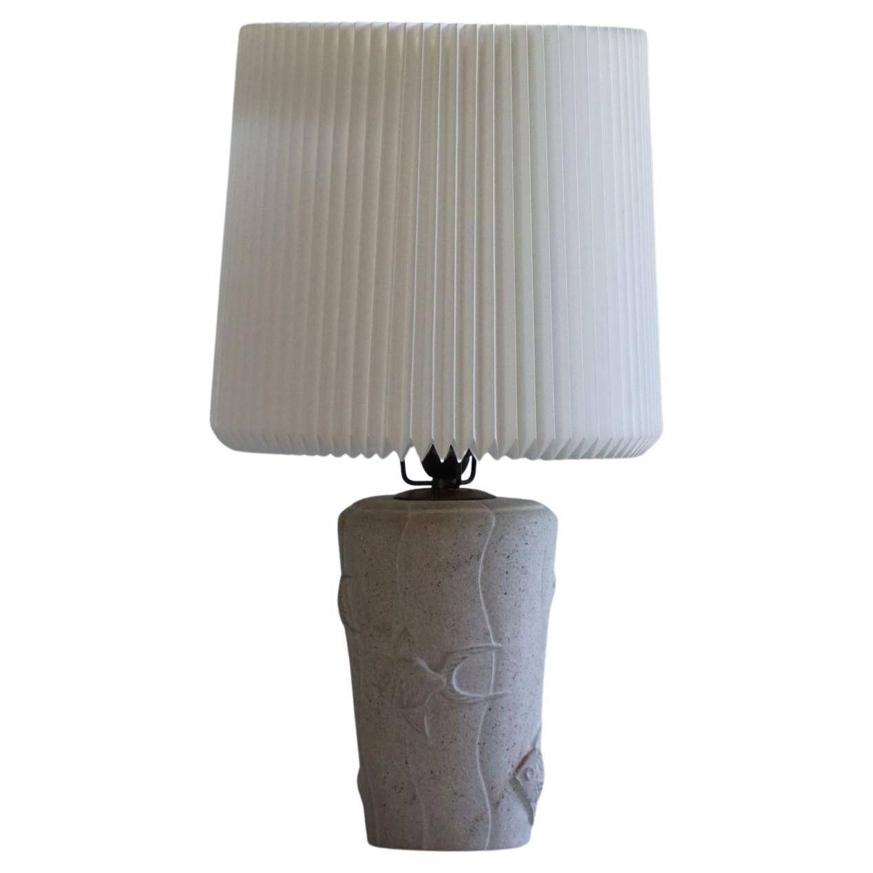 Modern vintage French table lamp, made of stone with fish patterns, 1970s.