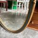 Oval mirror in wood and green and gold stucco, 75 x 42 cm