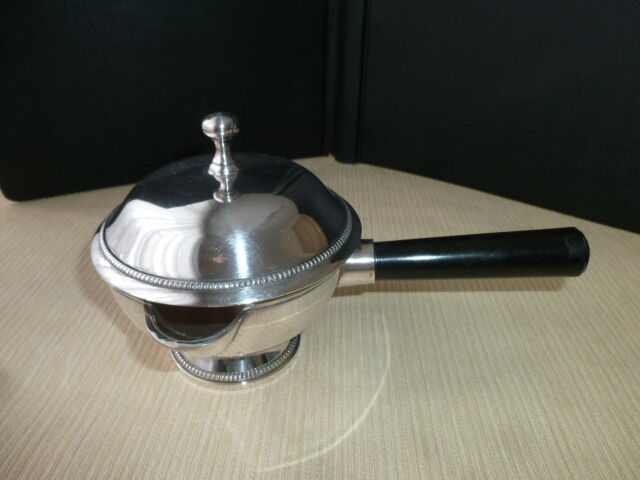 Covered saucepan with silver metal tail