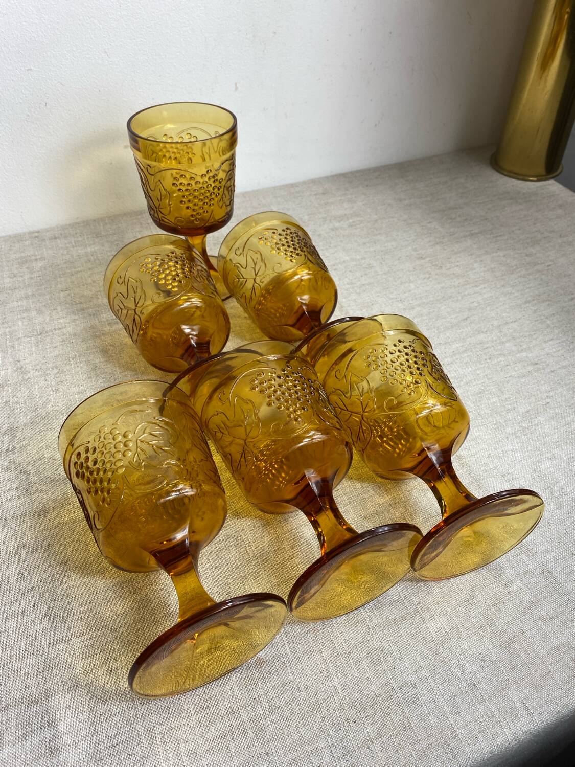 Six stemmed glasses in amber-colored molded glass