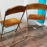 Two gold velvet folding chairs