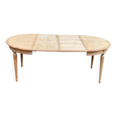 Extendable round table in renovated Louis XVI style, made of light wood, with 2 extensions.