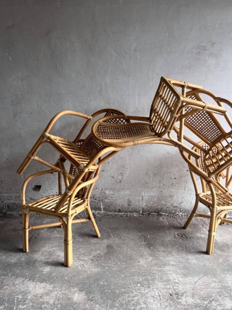 Set of 8 Manou rattan chairs with cane backrest.