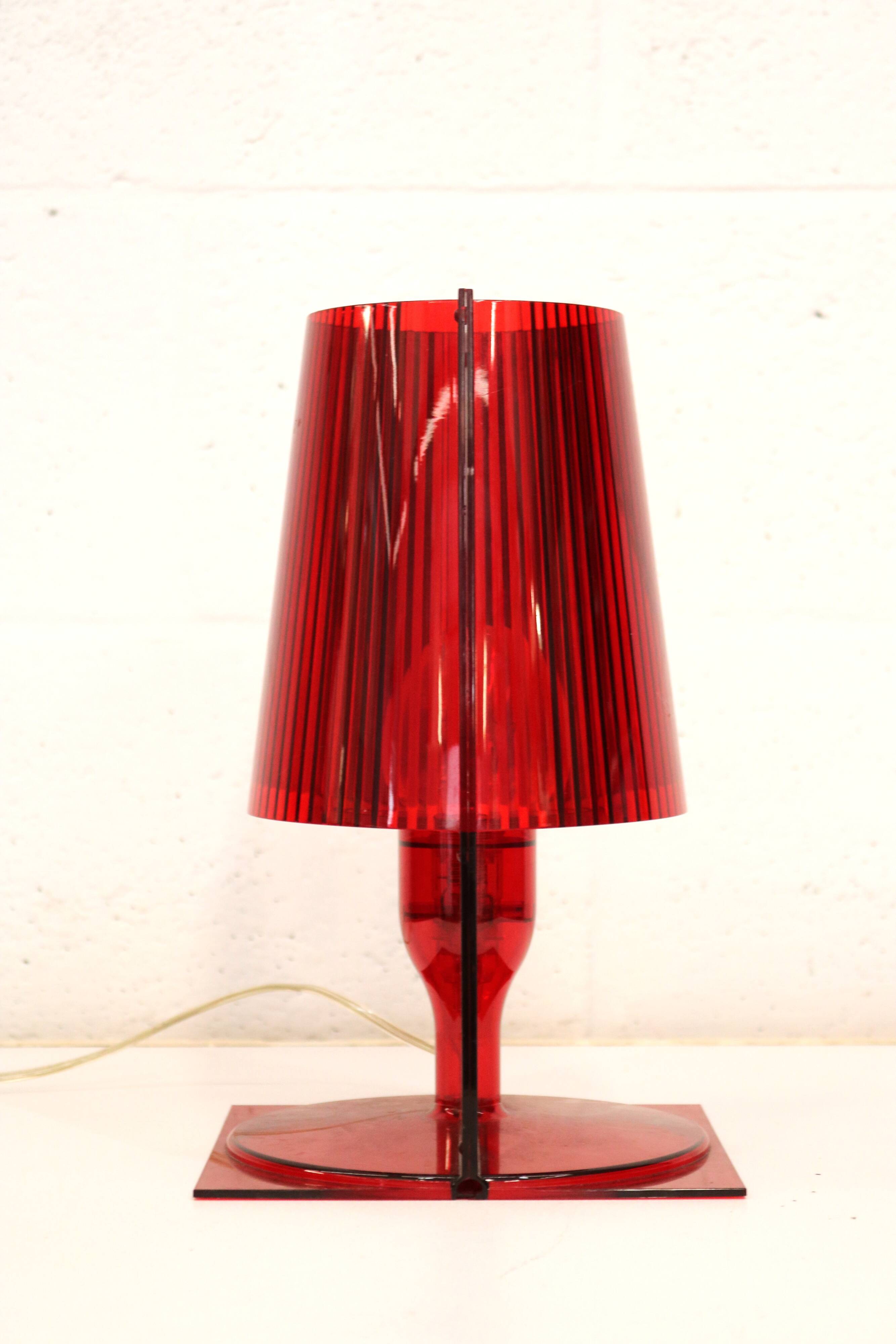 Red plastic Kartell table lamp - model Take - design by Ferruccio Laviani
