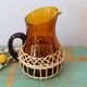 Amber glass decanter dressed in wicker, vintage