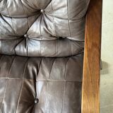 1970s Scandinavian armchair in curved laminated wood with a leather seat.