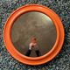 Mirror with round frame in orange molded plastic by carrara & matta, 1974