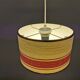 Hanging lamp with brass-coloured details, made of fabric with intact plastic bottom grille.