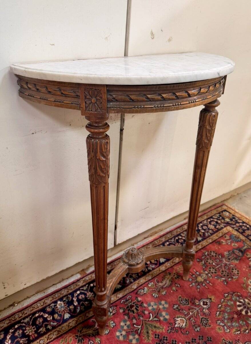 Half-moon console in Louis XVI style made of carved wood.