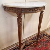 Half-moon console in Louis XVI style made of carved wood.