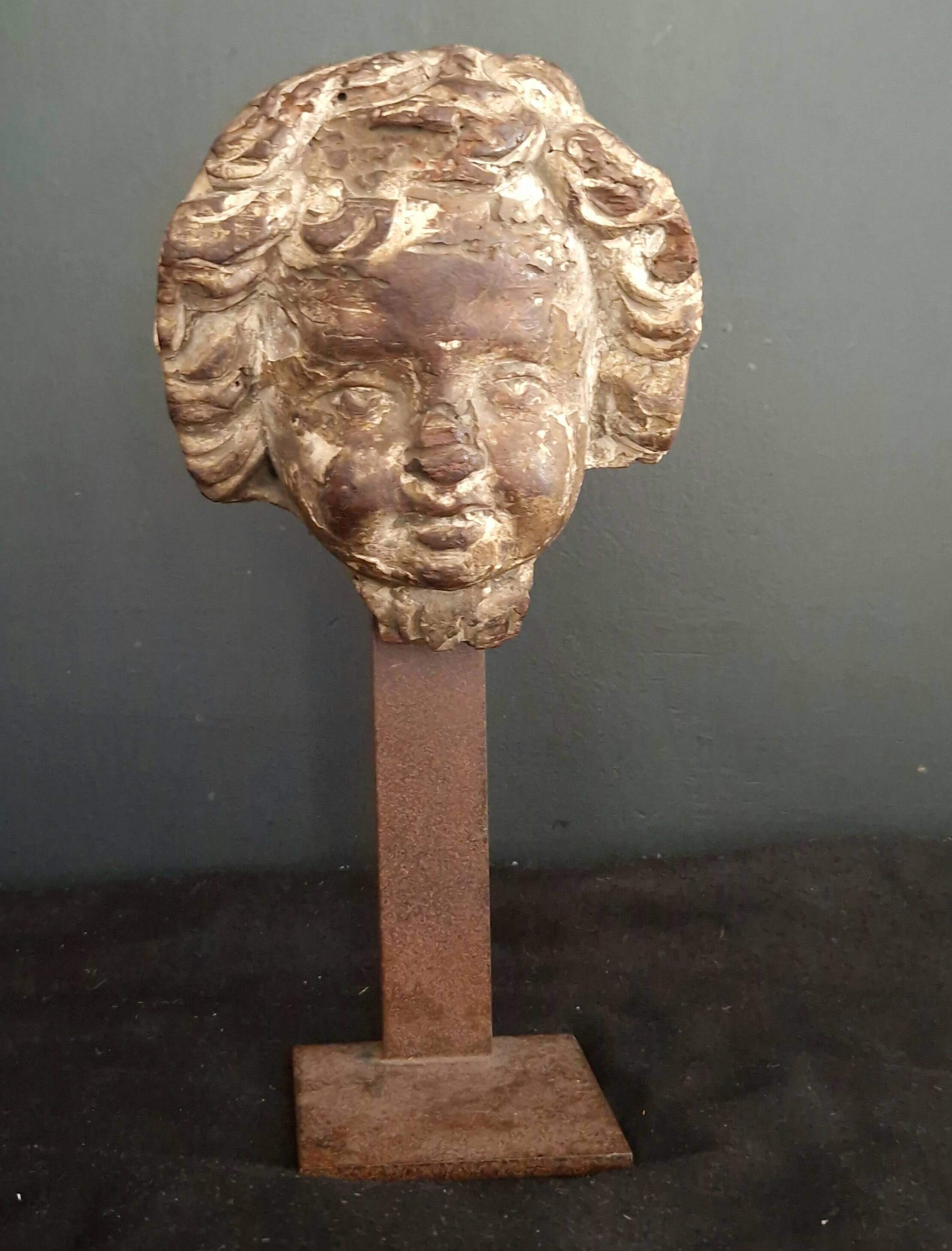 Sculpture. Ancient wooden angel head.