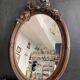 Miroir ovale ancien en bois sculpté et noeud de style Louis XVI