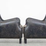 Set of 2 black cow leather armchairs finished with decorative nails, industrial style