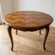 Round extendable dining table in Regency style made of cherry wood.