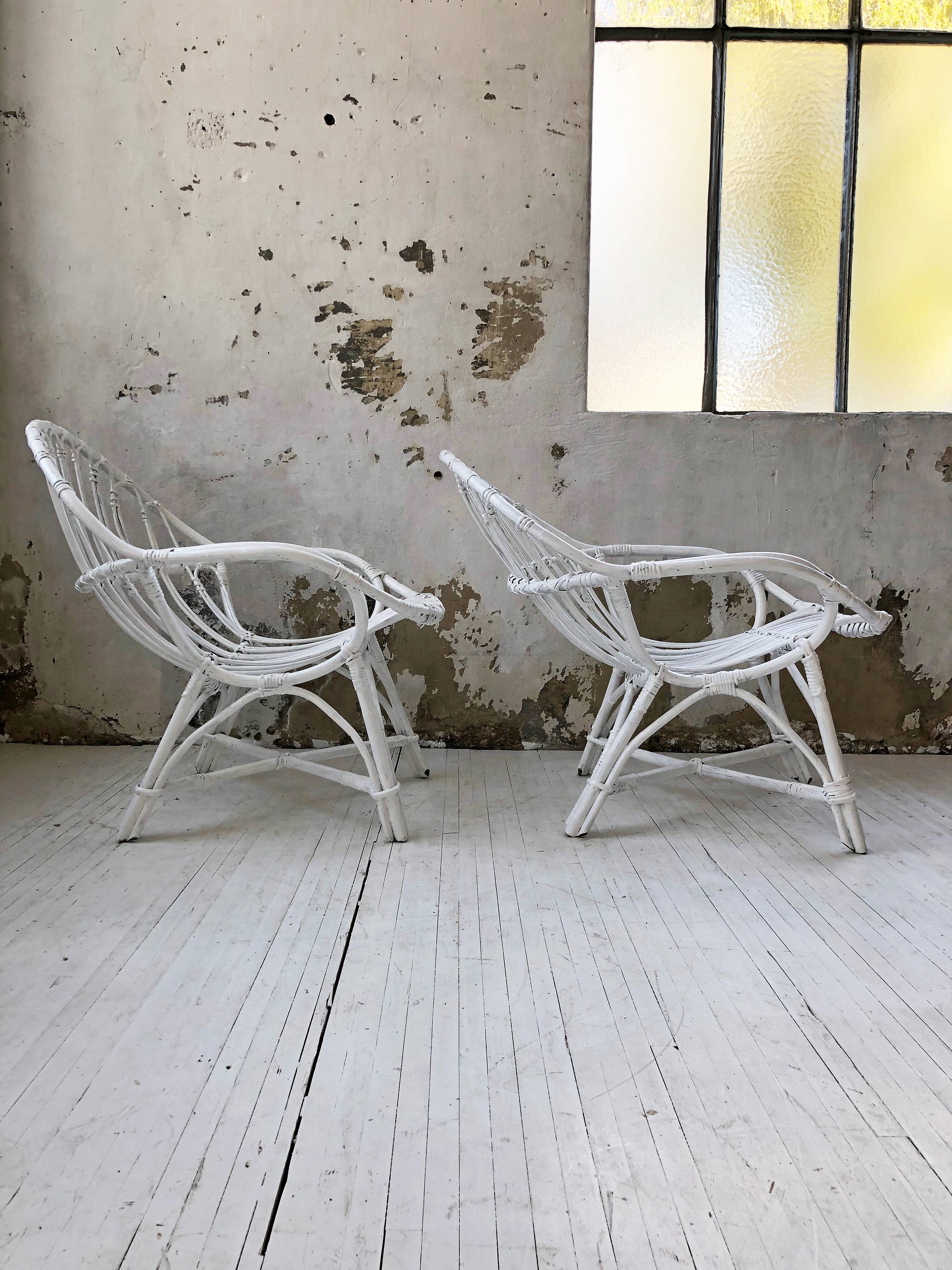 Pair of white rotin armchairs