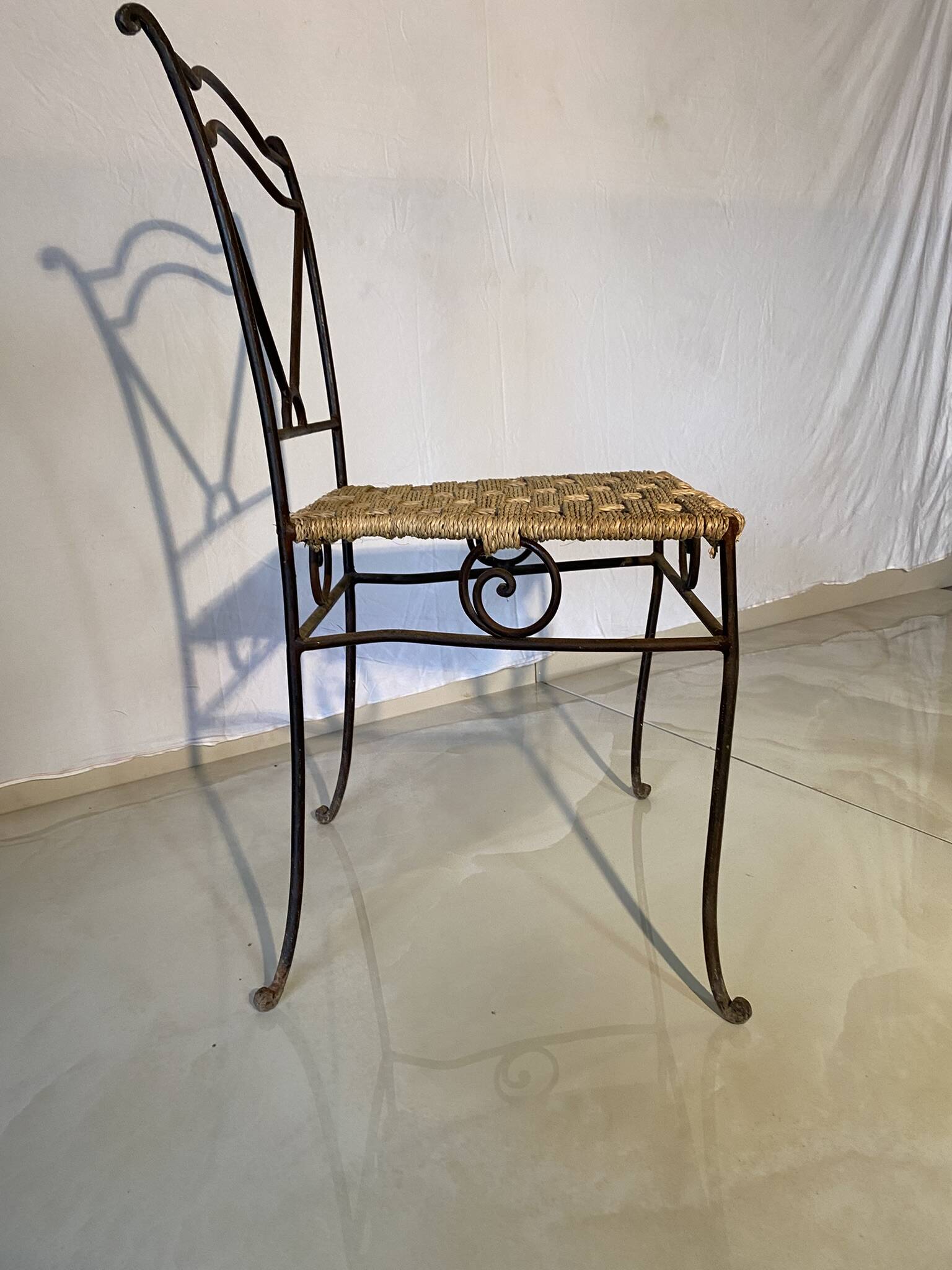 Wrought iron chair with woven seat