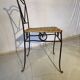 Wrought iron chair with woven seat
