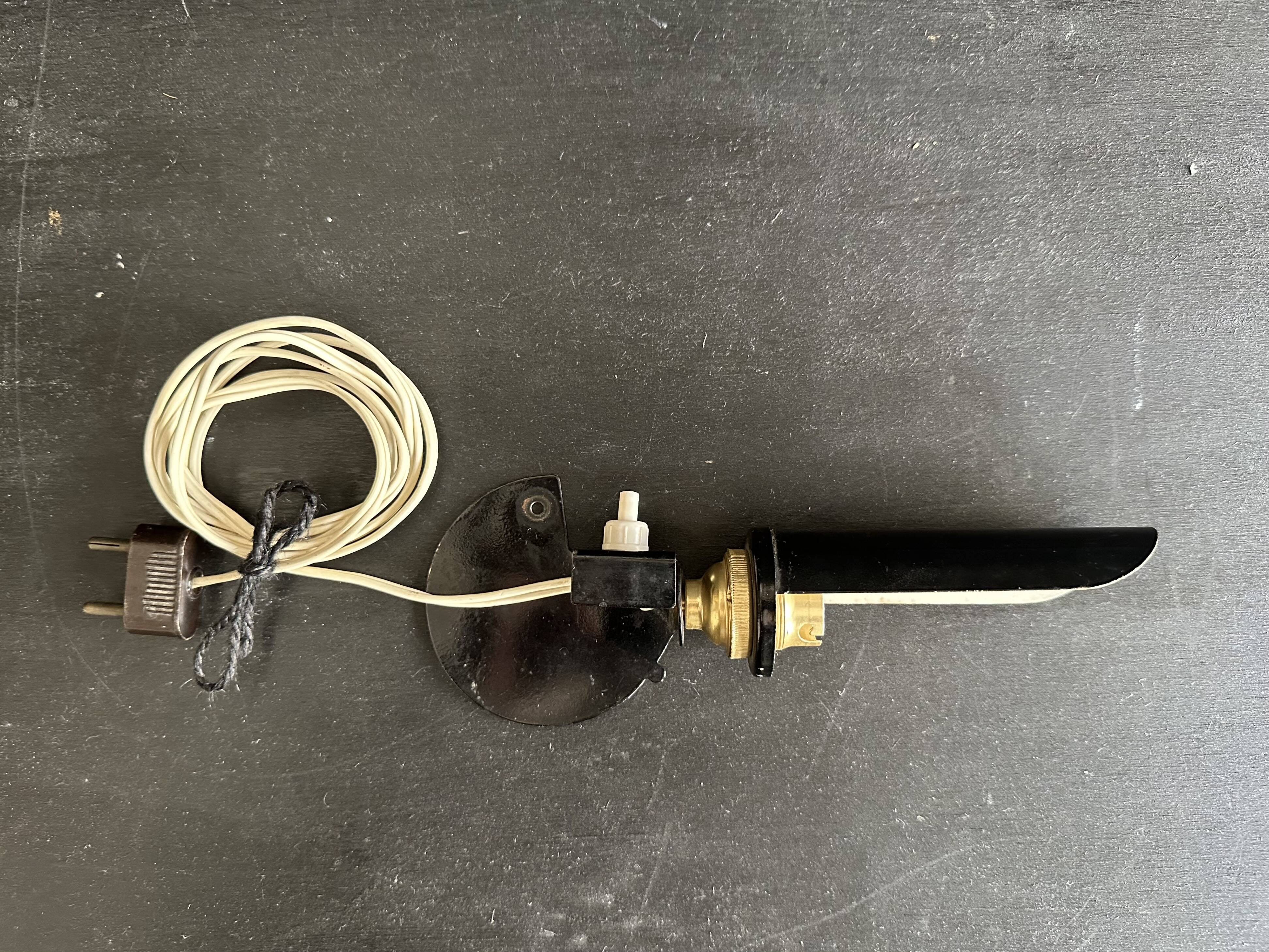 Old black metal and brass wall light, adjustable, 1930s.