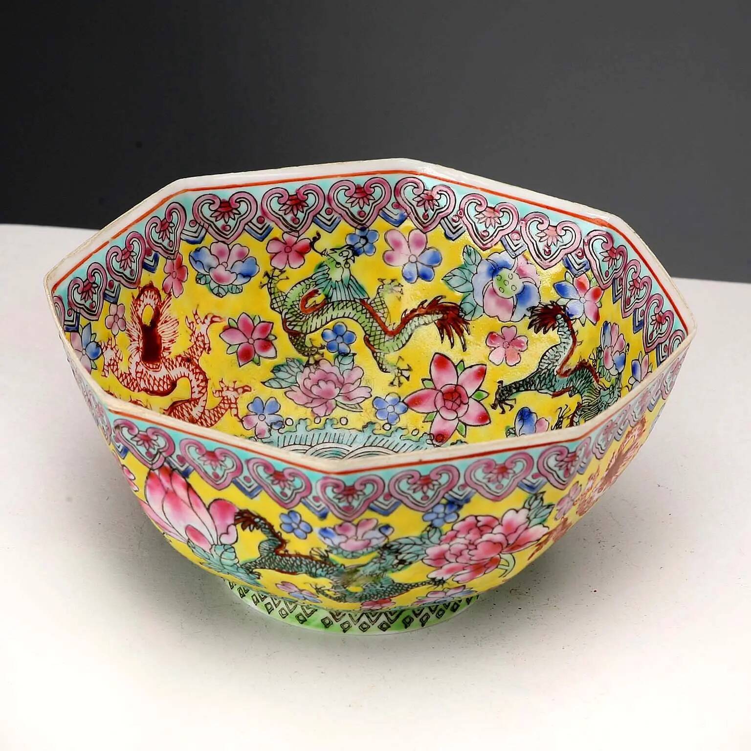 Vintage porcelain bowl decorated with dragons and flowers, China, 1980s.