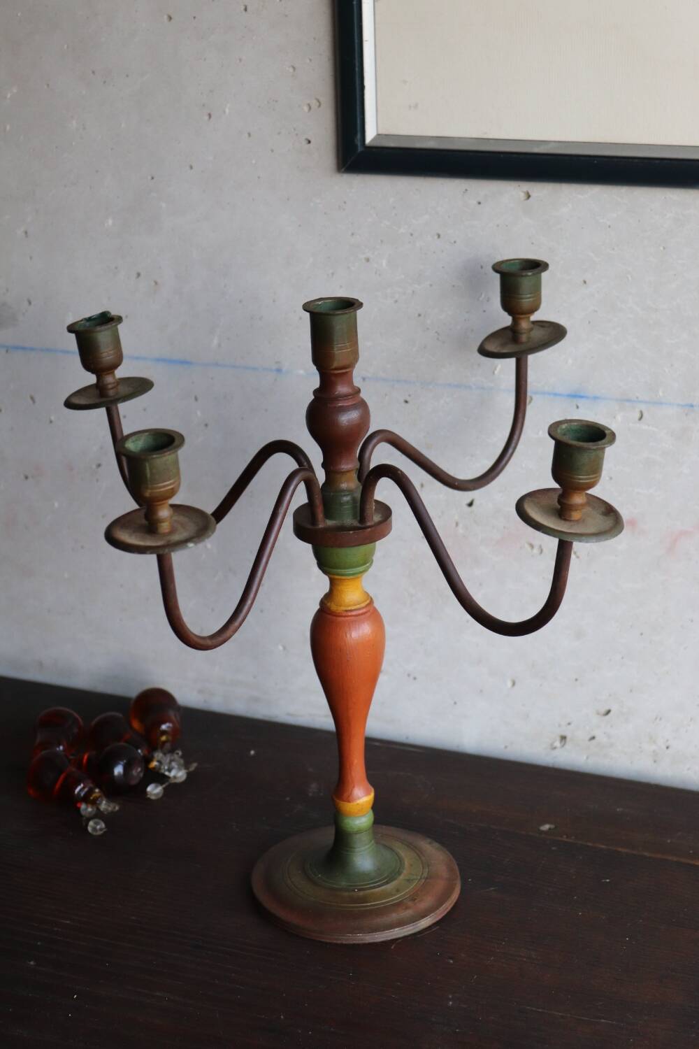 Old candlestick in painted wood and folding metal