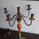 Old candlestick in painted wood and folding metal