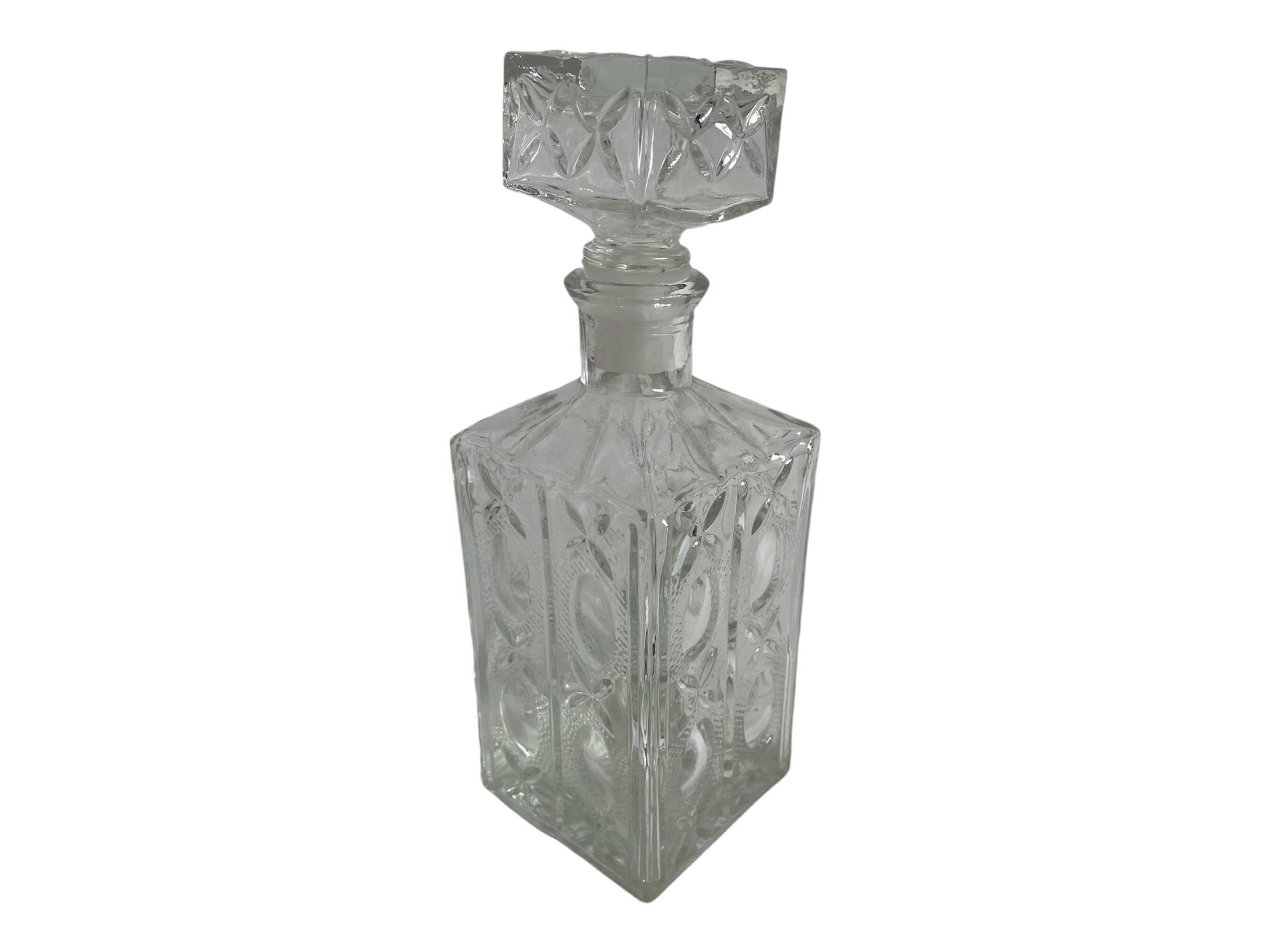 Molded glass carafe, 1960s-1970s, stylized flower decoration, oval, square base, stopper, rosette