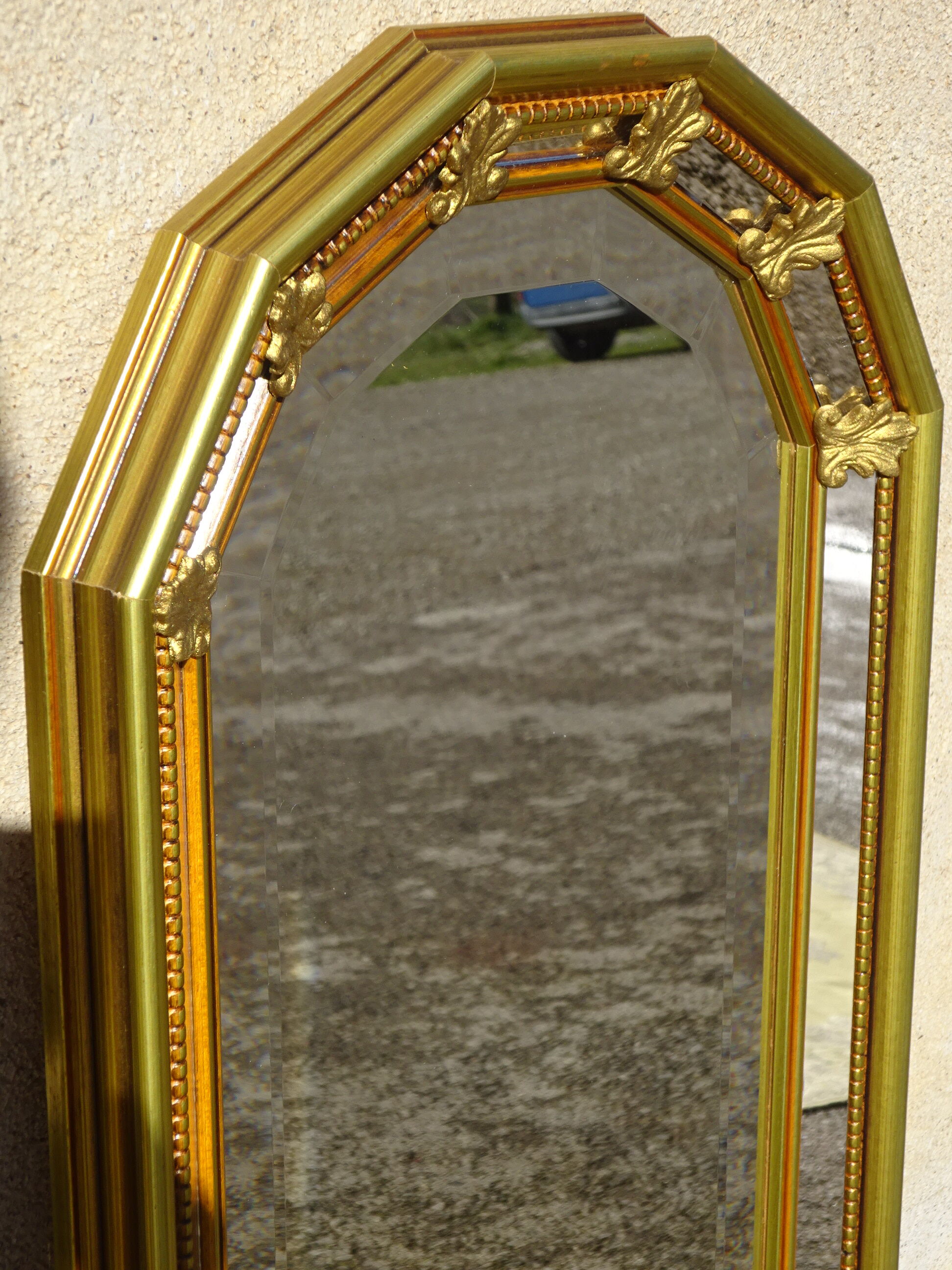 Vertical mirror, gold frame with beading.