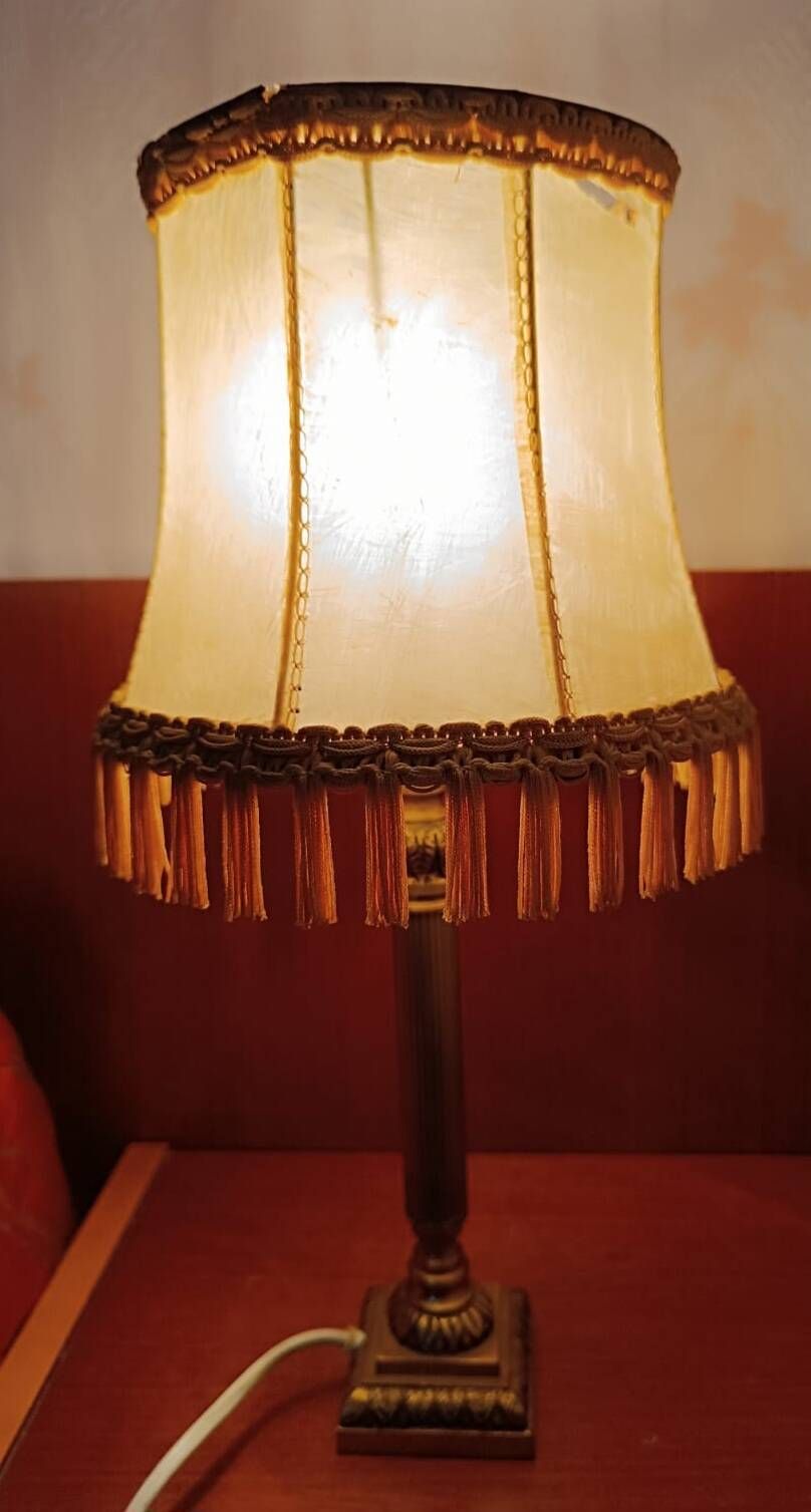 Brass bedside lamp with natural bladder shade.