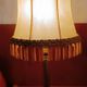 Brass bedside lamp with natural bladder shade.
