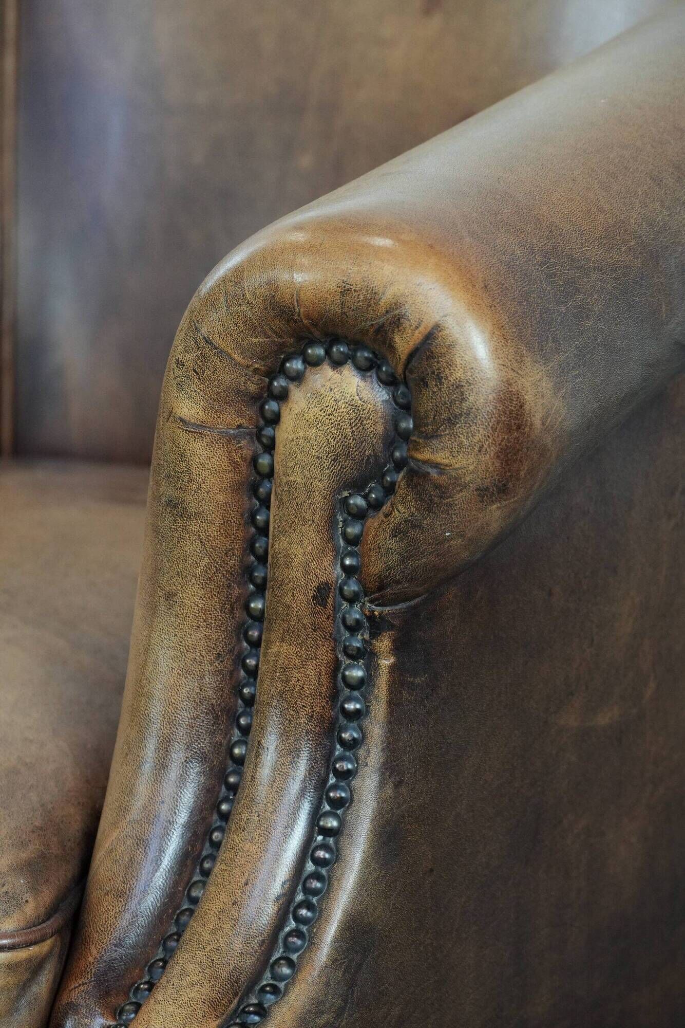 Club chair made of sheepskin leather finished with decorative nails