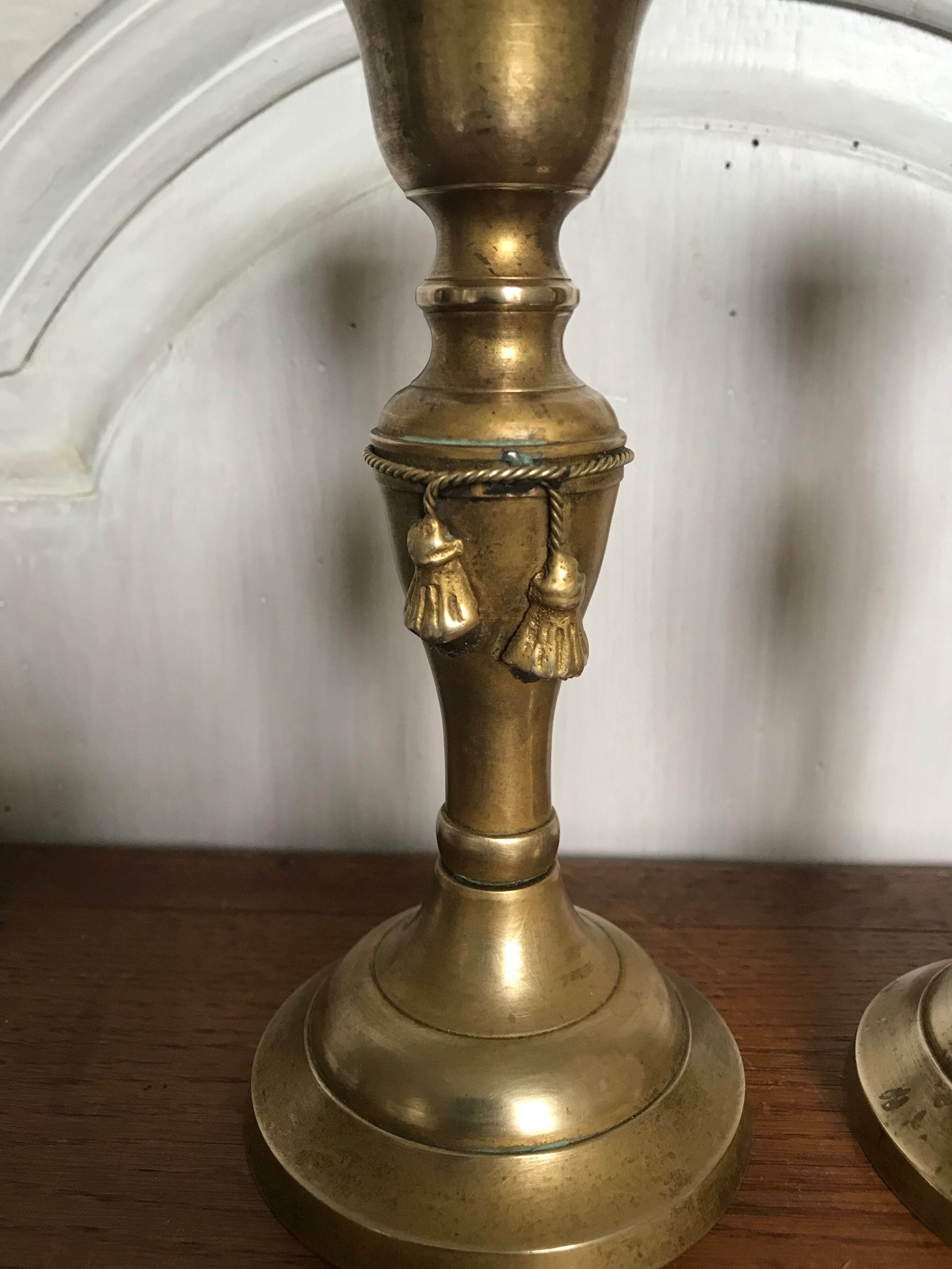 Pair of brass candlesticks with tassels