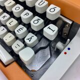 WE typewriter orange